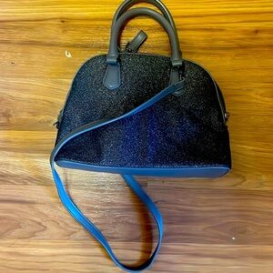 Grey sparkled purse, big enough to hold a book and a small tablet.